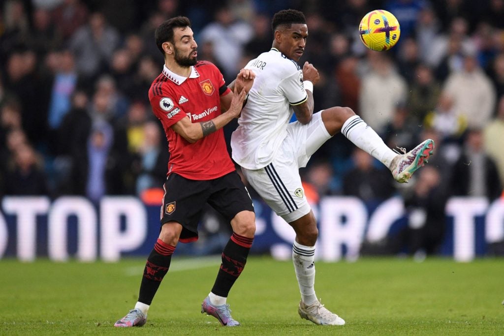 Man United's Bruno Fernandes challenges Leeds United star Junior Firpo.