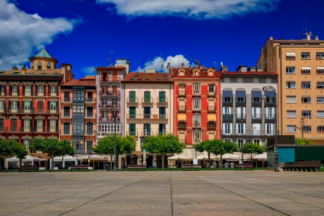 The Historic Plaza del Castillo in Pamplona, Spain, famous for the Running of the Bulls, on a bright day.