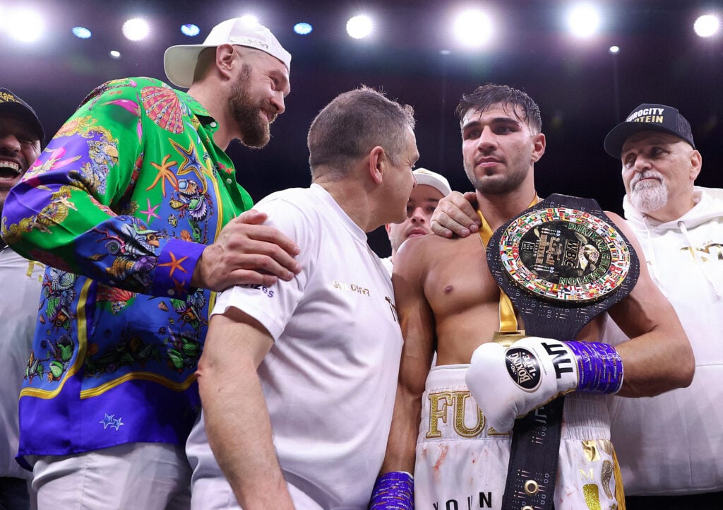 Tyson Fury celebrates with Tommy Fury (holding a WBC belt) and John Fury after his win over Jake Paul (not pictured)