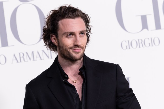 Aaron Taylor-Johnson smiling at a showbiz event