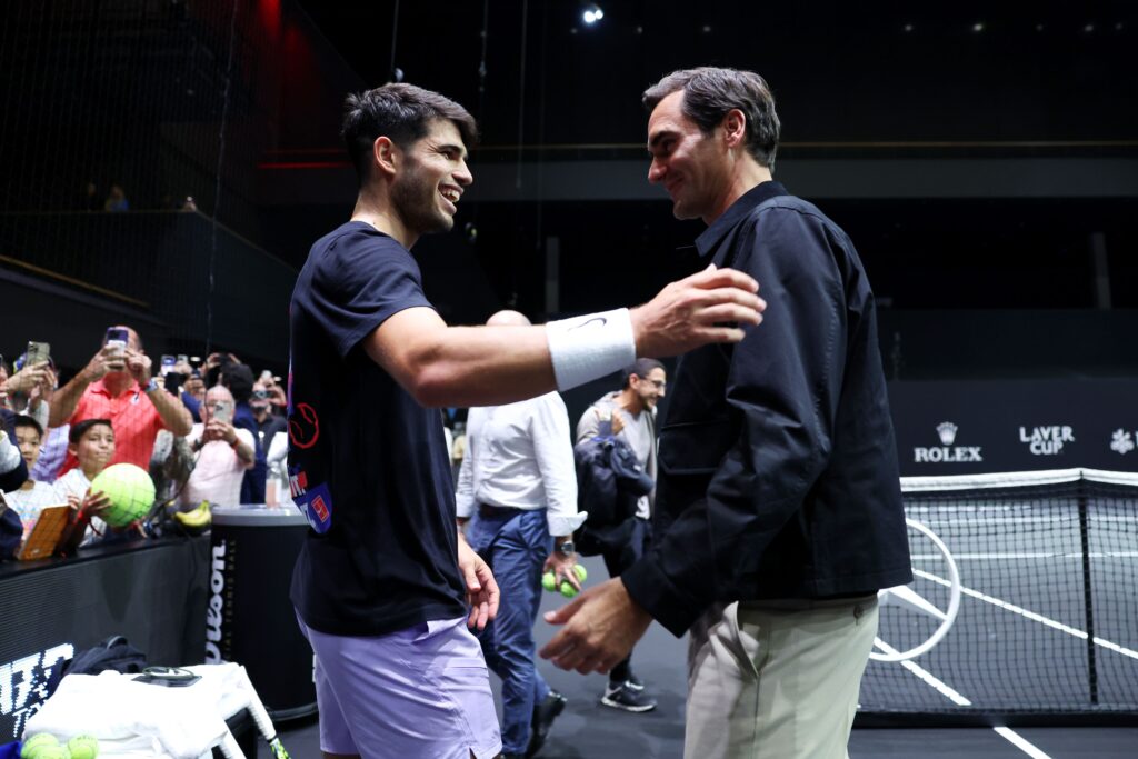 Carlos Alcaraz and Roger Federer embrace