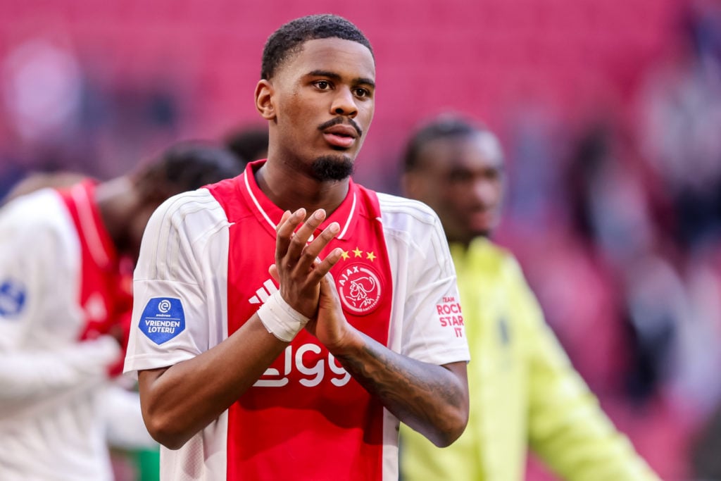 Jorrel Hato applauds after Ajax's Eredivisie match against Go Ahead Eagles.