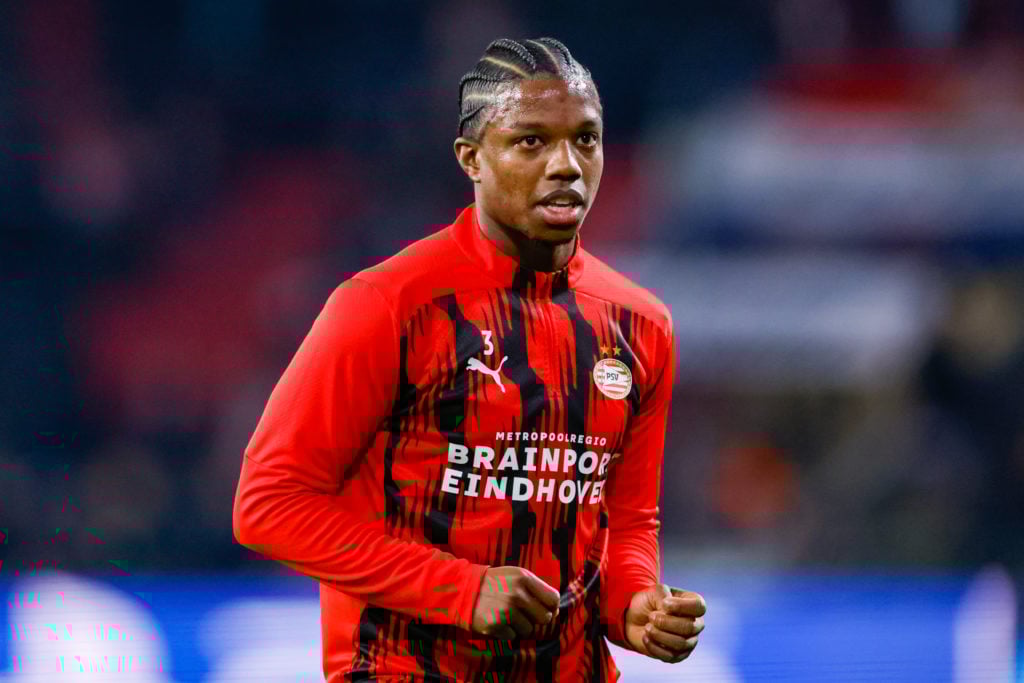 PSV Eindhoven's Tyrell Malacia warms up before facing Arsenal.