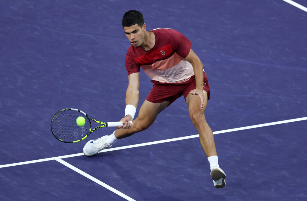Carlos Alcaraz of Spain plays a forehand volley against Denis Shapovalov of Canada in their third round match during the BNP Paribas Open at Indian Wells Tennis Garden on March 10, 2025 in Indian Wells, California.