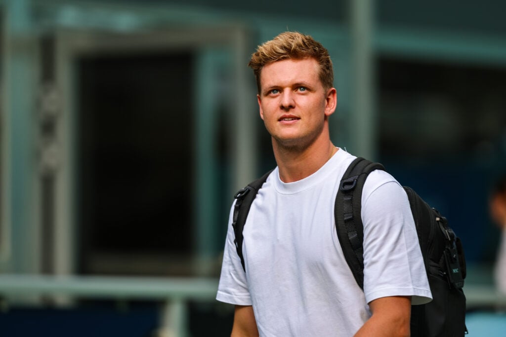 Mick Schumacher walks in the Formula 1 paddock
