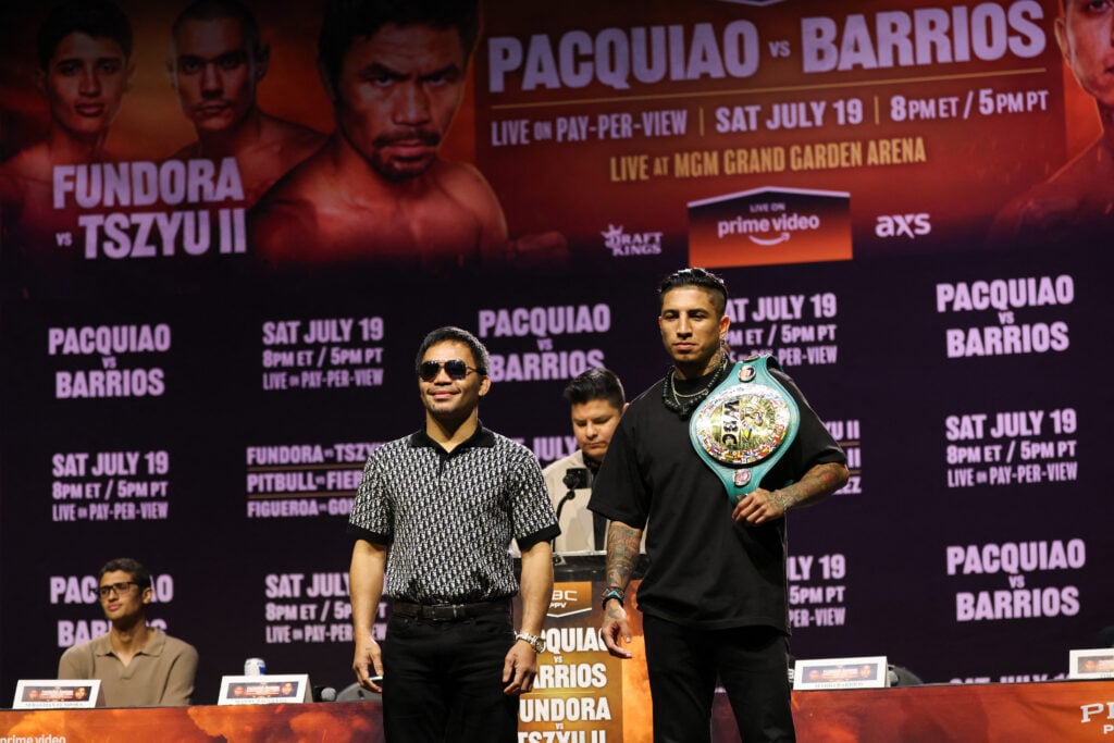 Manny Pacquiao stands beside Mario Barrios at their press conference, Barrios has a belt over his shoulder