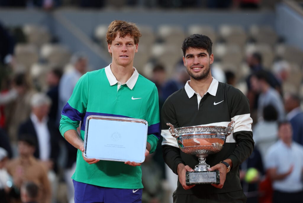 Carlos Alcaraz of Spain poses for a photo with the Coupe des Mousquetaires trophy alongside runner-up Jannik Sinner of Italy following his victory in the Men’s Singles Final match on Day Fifteen of the 2025 French Open at Roland Garros.