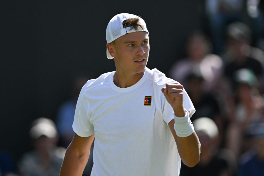 Denmark's Holger Rune reacts against Chile's Nicolas Jarry during their men's singles first round tennis match on the first day of the 2025 Wimbledon Championships at The All England Lawn Tennis and Croquet Club in Wimbledon, southwest London, on June 30, 2025.