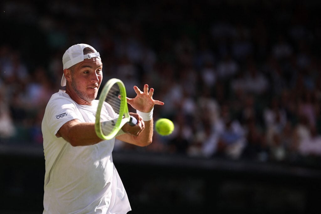 Jan-Lennard Struff hits a forehand against Carlos Alcaraz at Wimbledon