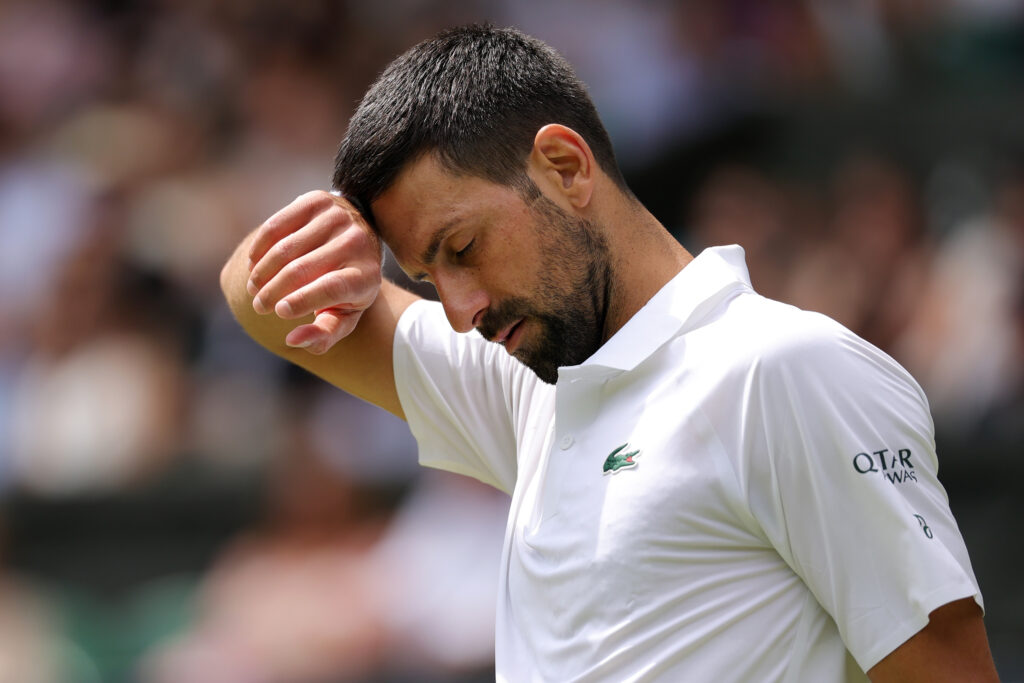 Novak Djokovic of Serbia looks dejected as he wipes his forehead against Alex De Minaur of Australia during the Gentlemen's Singles fourth round match on day eight of The Championships Wimbledon 2025 at All England Lawn Tennis and Croquet Club on July 07, 2025 in London, England.