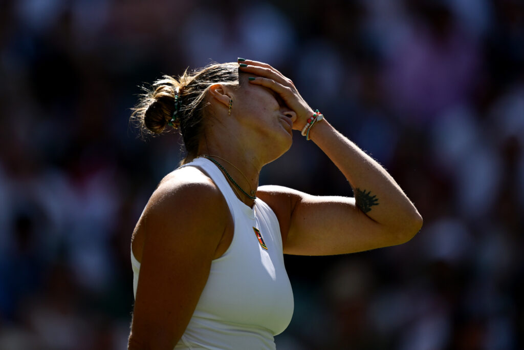 Aryna Sabalenka facepalms in frustration