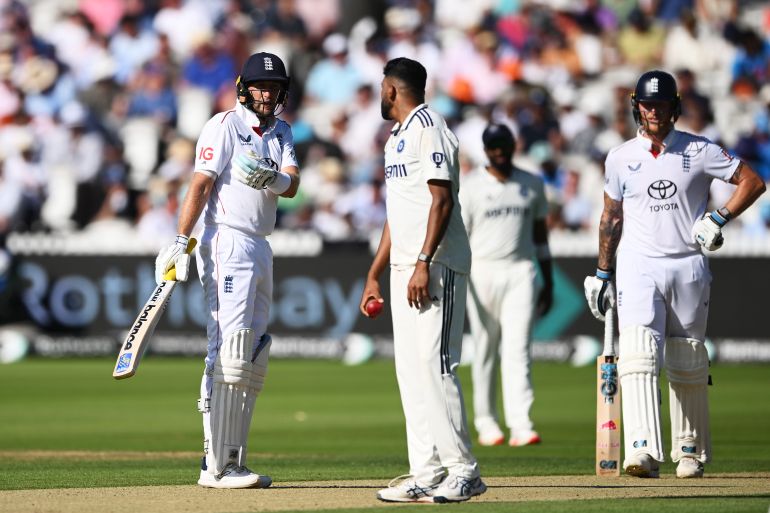 Joe Root of England (L) and Mohammed Siraj of India (C) talk during Day One of the 3rd Rothesay Test Match 
