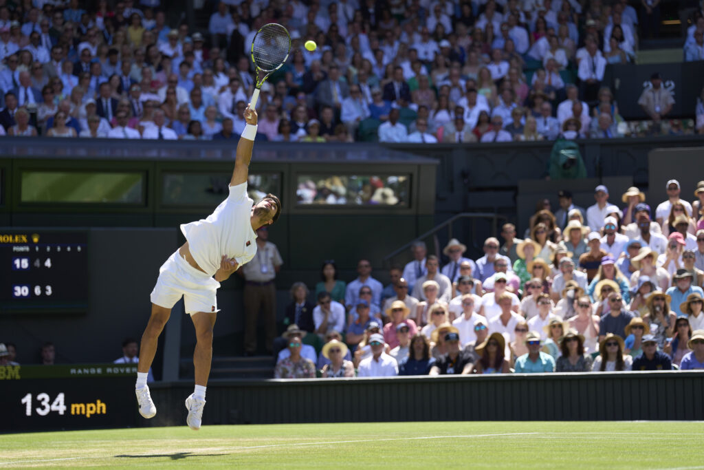 Carlos Alcaraz of Spain serves the ball against Taylor Fritz of the United States during the Gentlemen's semi-finals match on Centre Court on day twelve of The Championships Wimbledon 2025 at All England Lawn Tennis and Croquet Club on July 11, 2025 in London, England.