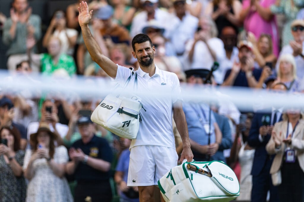 Novak Djokovic waves to the crowd after losing his semi-final to Jannik Sinner at The Championships - Wimbledon 2025