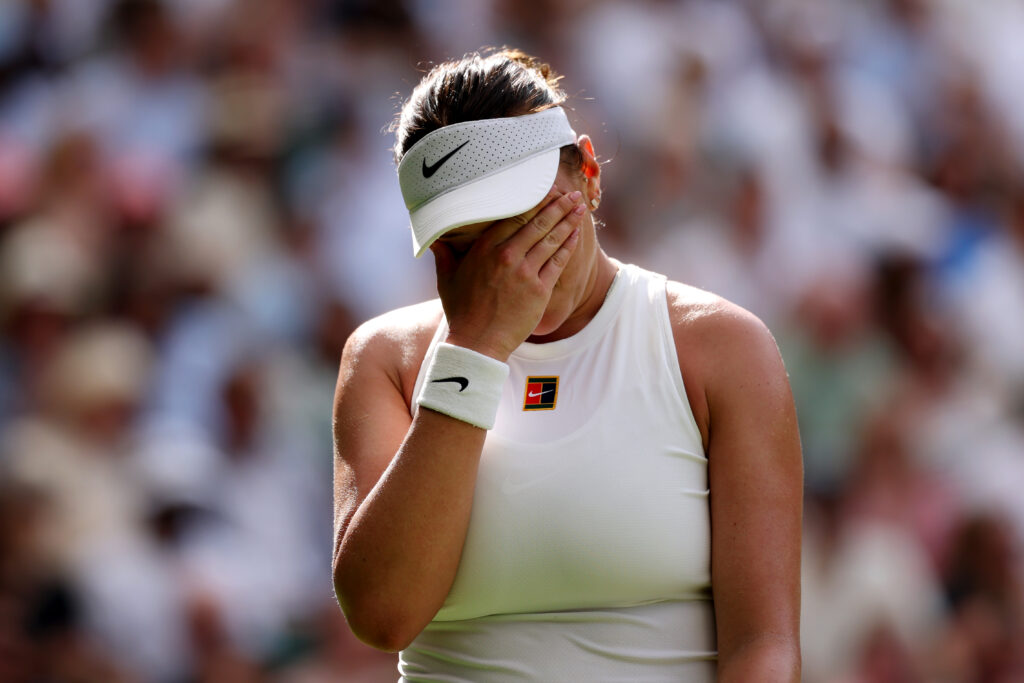Amanda Anisimova covers her face, crying