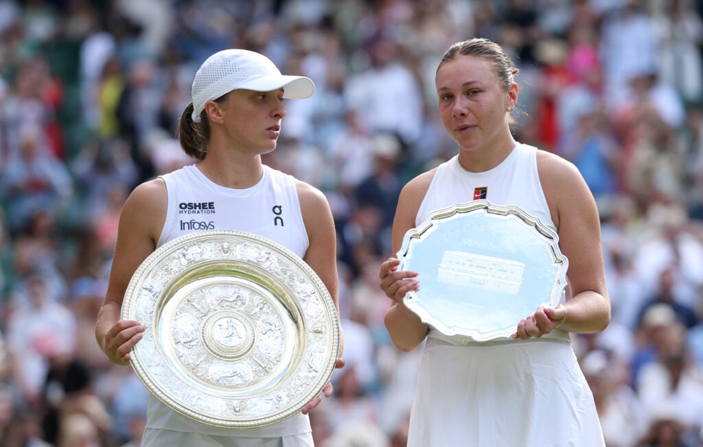 Iga Swiatek and Amanda Anisimova pose with their trophies after the 2025 Wimbledon final.
