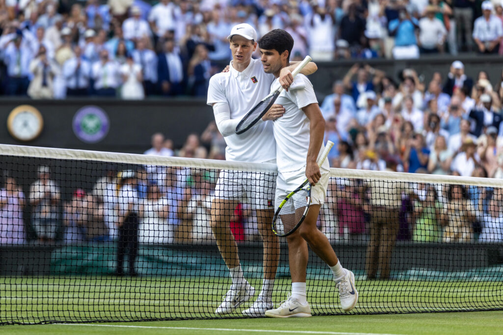 Winner Jannik Sinner of Italy and Carlos Alcaraz of Spain embrace at the net after the Gentlemen's Singles Final on Centre Court during the Wimbledon Lawn Tennis Championships at the All England Lawn Tennis and Croquet Club at Wimbledon on July 13th, 2025, in London, England.