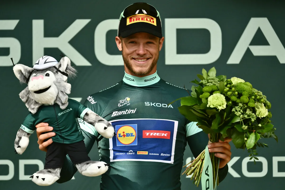 Lidl - Trek team's Italian rider Jonathan Milan celebrates on the podium with the best sprinter's green jersey.