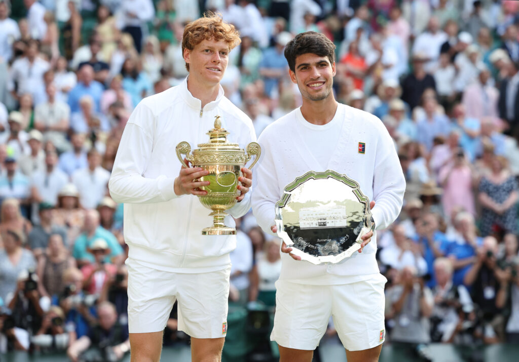 Jannik Sinner (ITA) [1] and Carlos Alcaraz (ESP) [2] with their trophies after the Gentlemen's Singles Final match during day fourteen of The Championships Wimbledon 2025 at All England Lawn Tennis and Croquet Club on July 13, 2025 in London, England.