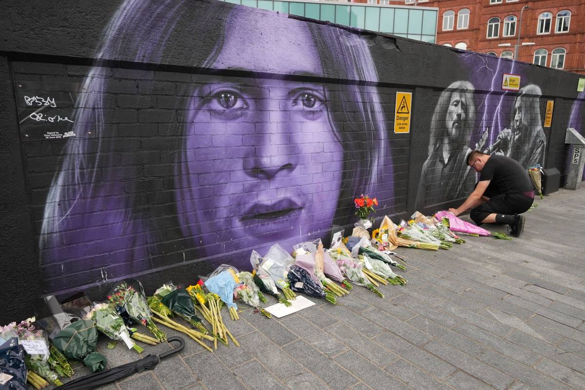 BIRMINGHAM, ENGLAND - JULY 23: Flowers are placed in memory of Ozzy Osbourne next to a mural in Navigation Street on July 23, 2025 in Birmingham, England. Ozzy Osbourne, the legendary rock icon and Black Sabbath frontman, died on Tuesday, aged 76, after performing a farewell show in his hometown of Birmingham earlier this month. Over the course of his storied career as a singer-songwriter and media personality, he brought home five Grammy Awards and was twice inducted into the Rock and Roll Hall of Fame - once as a member of Black Sabbath, and again as a solo artist. (Photo by Christopher Furlong/Getty Images)