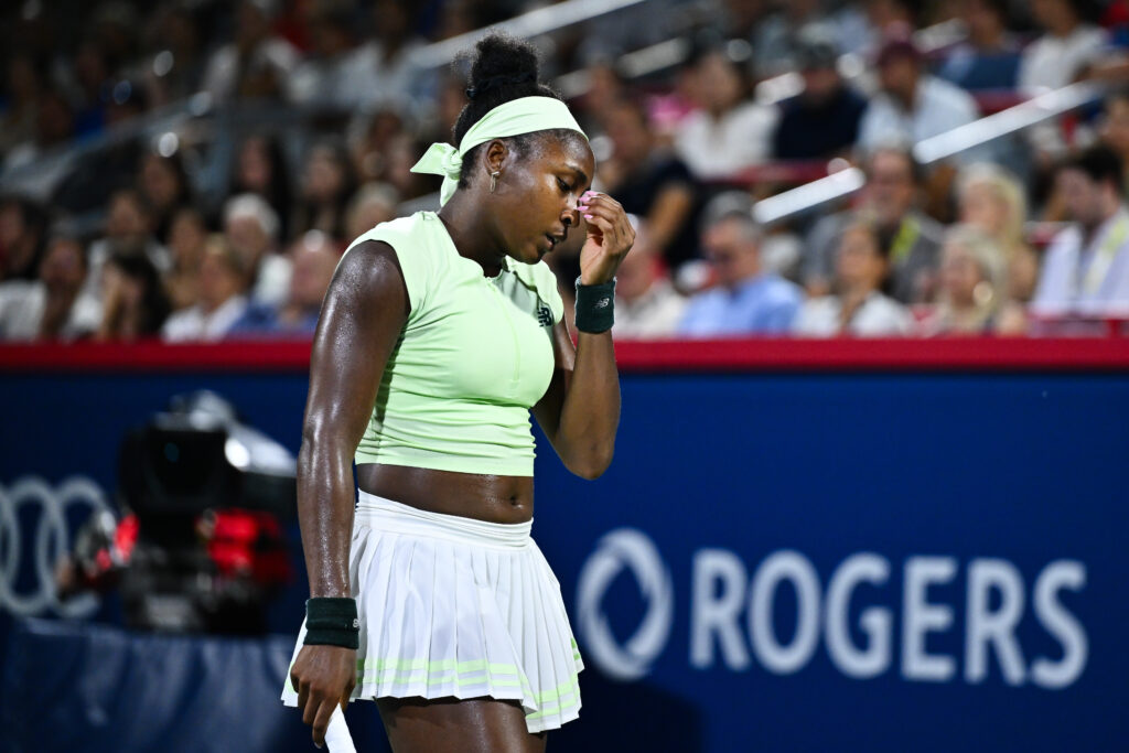 Coco Gauff clutches her face, looking dejected