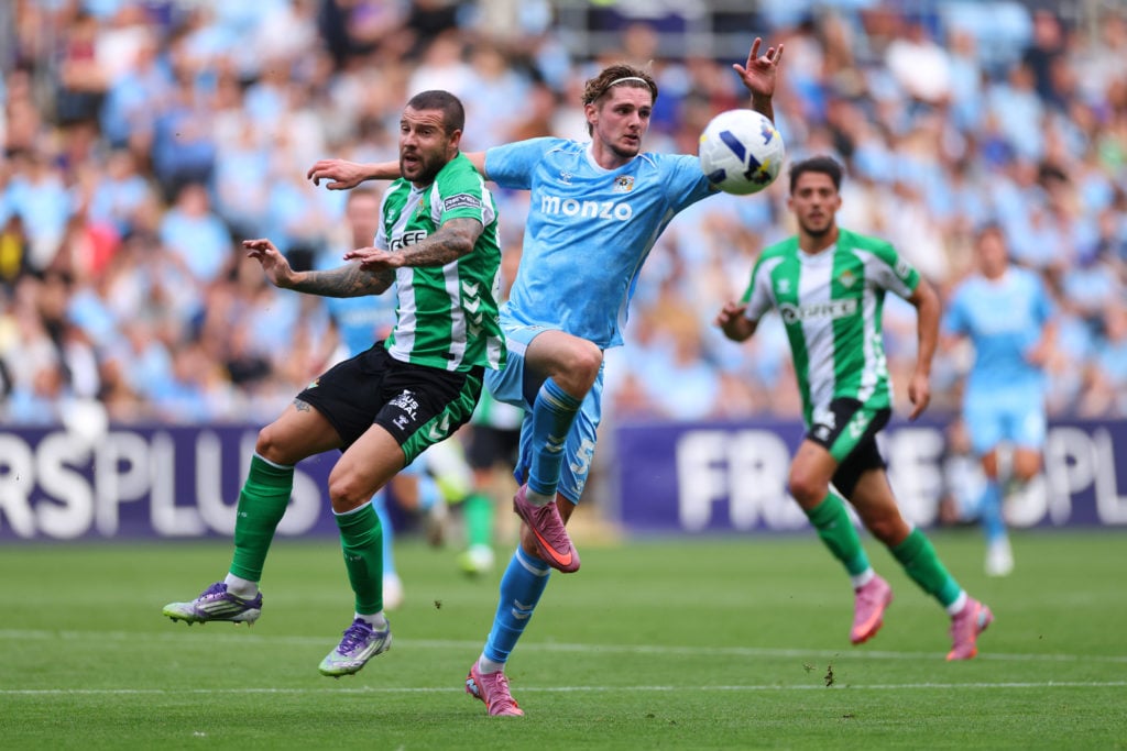 Jack Rudoni wins the ball for Coventry in a friendly against Betis.