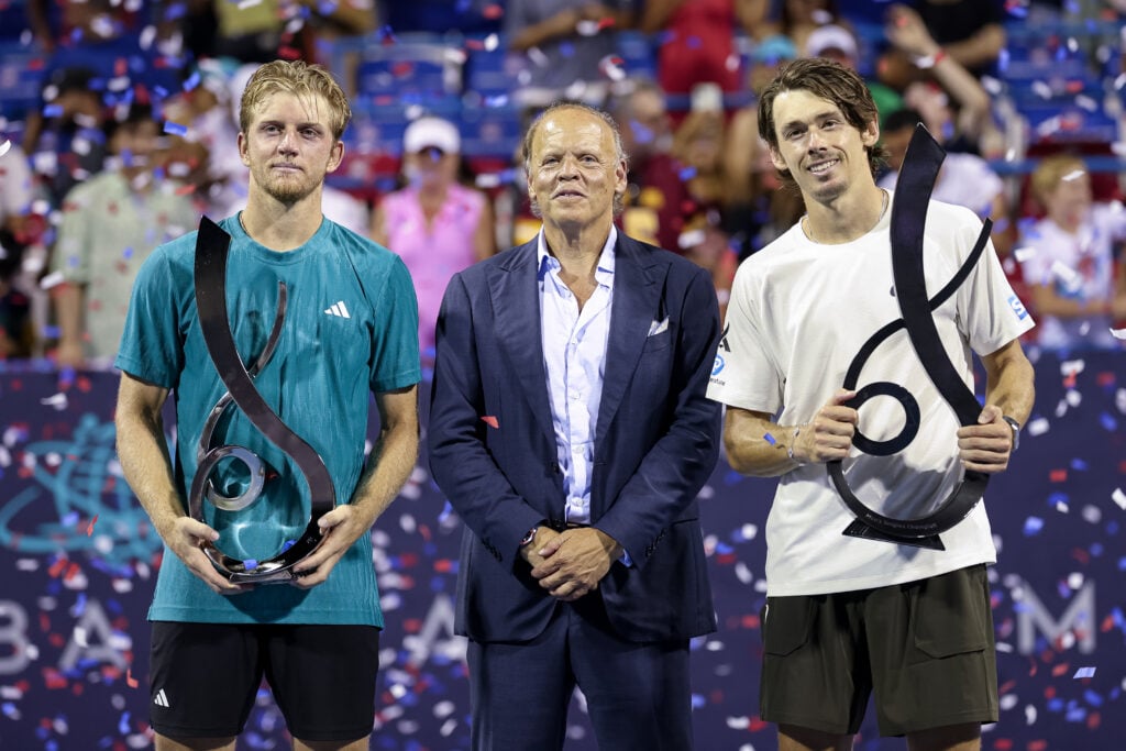 Alejandro Davidovich Fokina of Spain, tournament chairman Mark Ein, and Alex De Minaur of Australia pose with the men's singles trophies after a men's singles finals match on the final day of the Mubadala Citi DC Open 2025 at William H.G. FitzGerald Tennis Center.