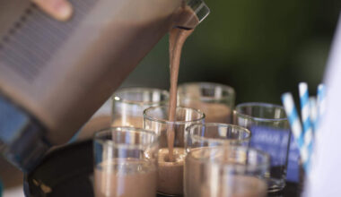 Someone adds Quest Nutrition protein powder to a shake. (Christopher Polk/Getty Images for Quest)
