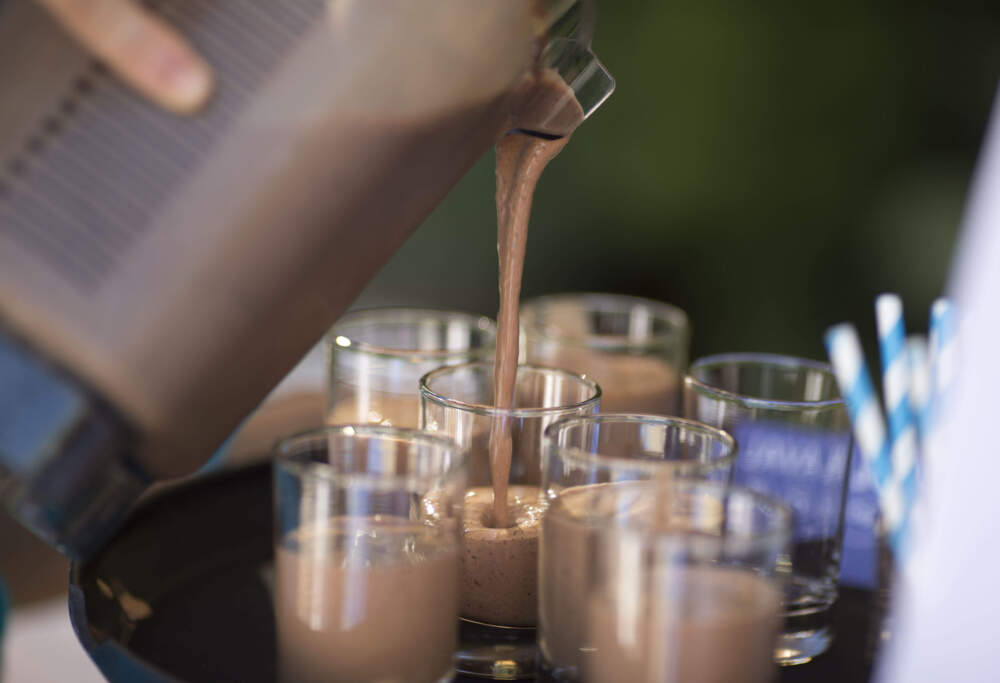 Someone adds Quest Nutrition protein powder to a shake. (Christopher Polk/Getty Images for Quest)