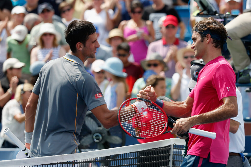 Roger Federer and Novak Djokovic shake hands at the net