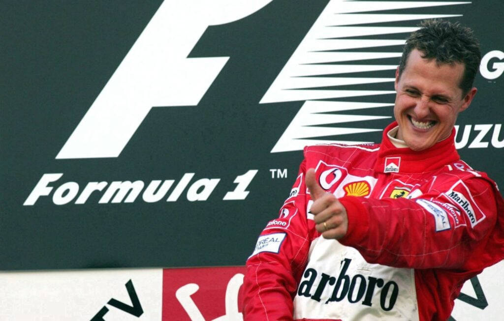 Ferrari driver Michael Schumacher celebrates winning the 2004 Japanese Grand Prix at Suzuka