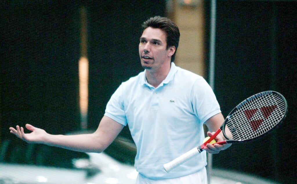 German tennis player Michael Stich waving his hands in 2004.