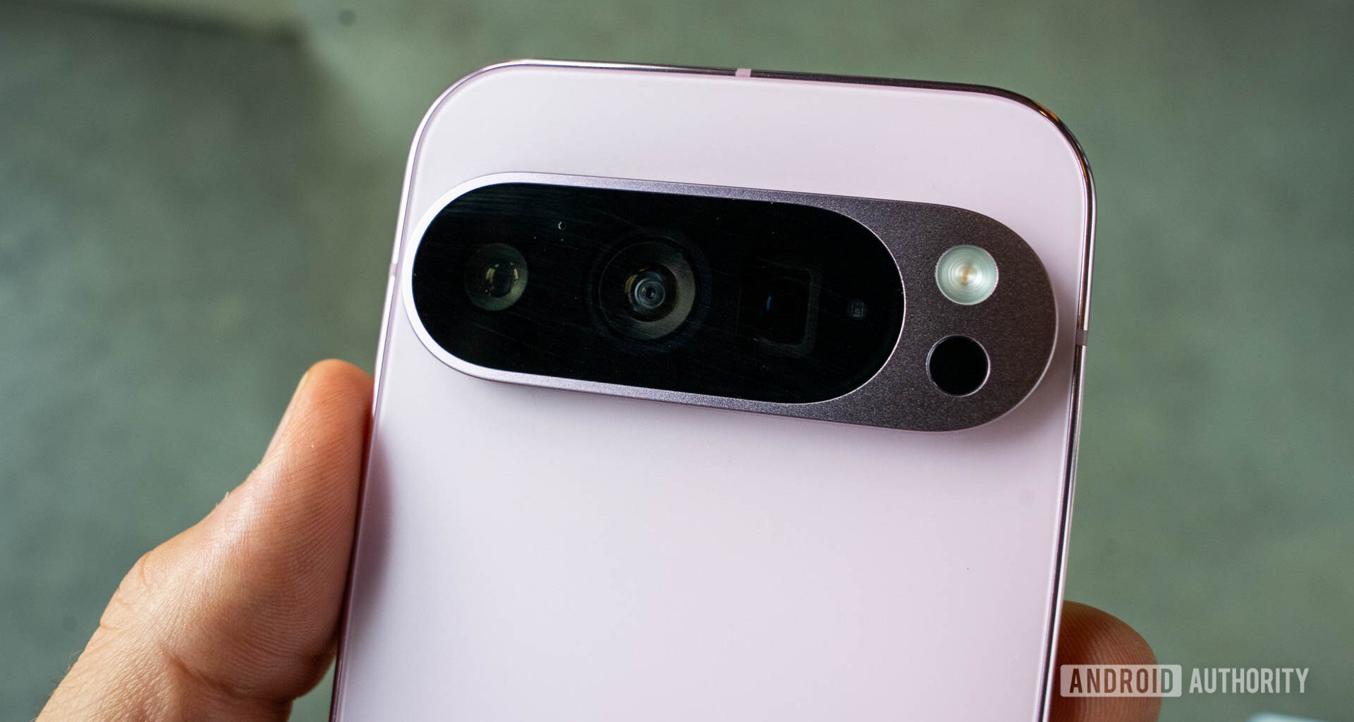 Google Pixel 9 pro in Rose Quartz with a close up on its rear camera module