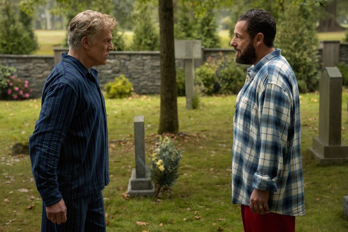 Christopher McDonald as Shooter McGavin and Adam Sandler as Happy Gilmore in Happy Gilmore 2 staring each other down in a graveyard