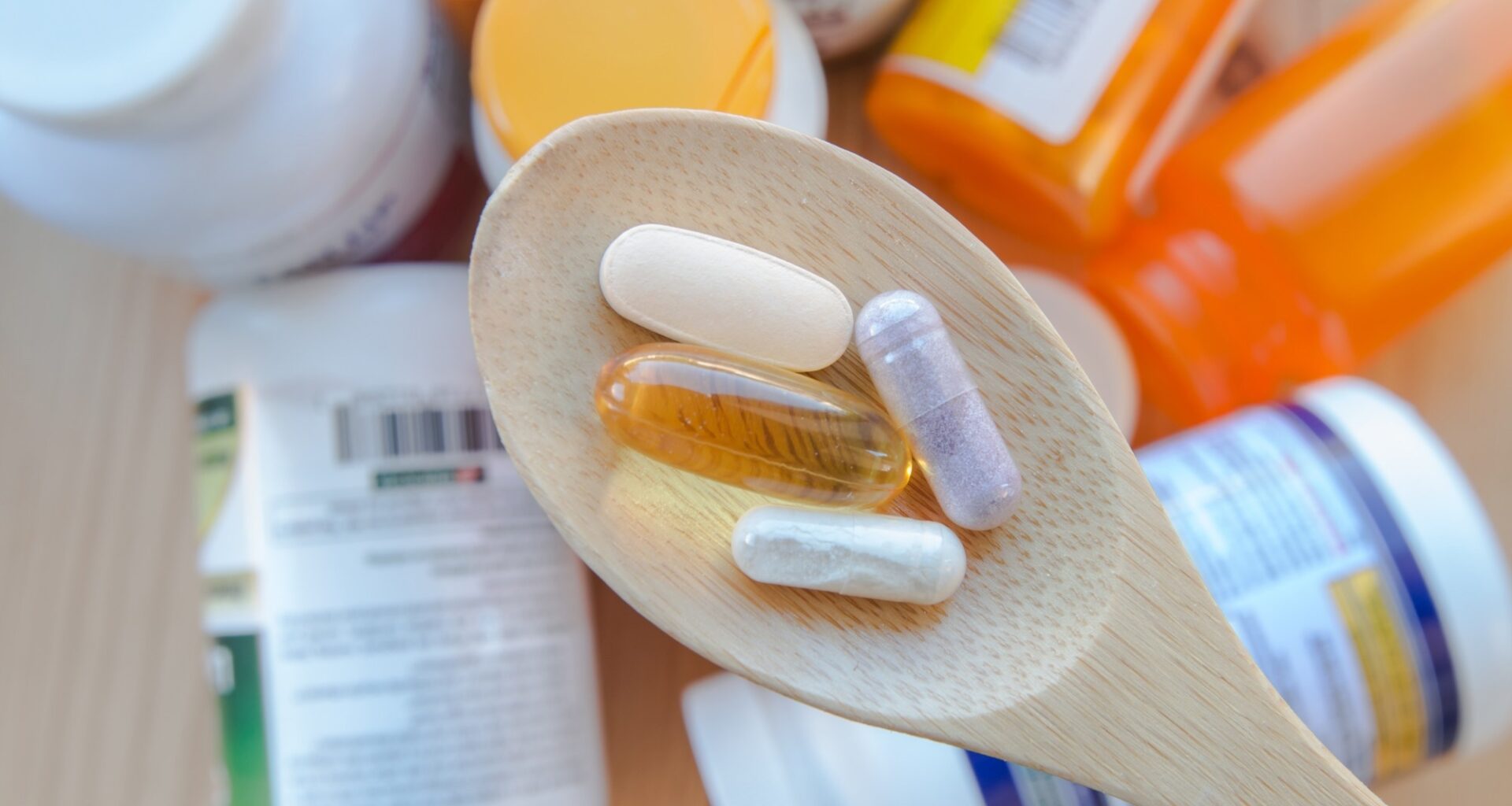 supplements and vitamins are in a wooden spoon