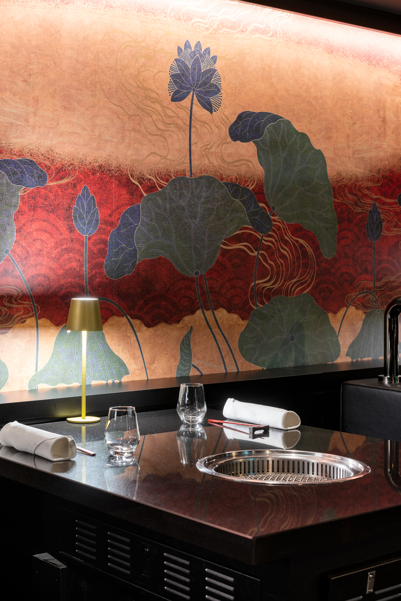 the opulent interior of kanpai classic, showing a table set for two with a sunken recessed BBQ in the table