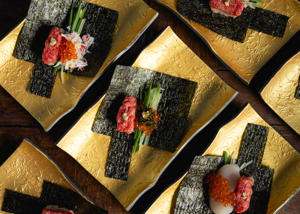 a selection of temaki sushi handrolls, presented in golden tables unrolled to see how much filling is inside