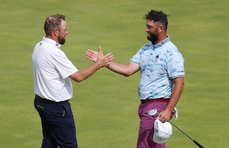 Shane Lowry and Jon Rahm shake hands after finishing their round on the 18th green. Photograph: Andrew Redington/Getty