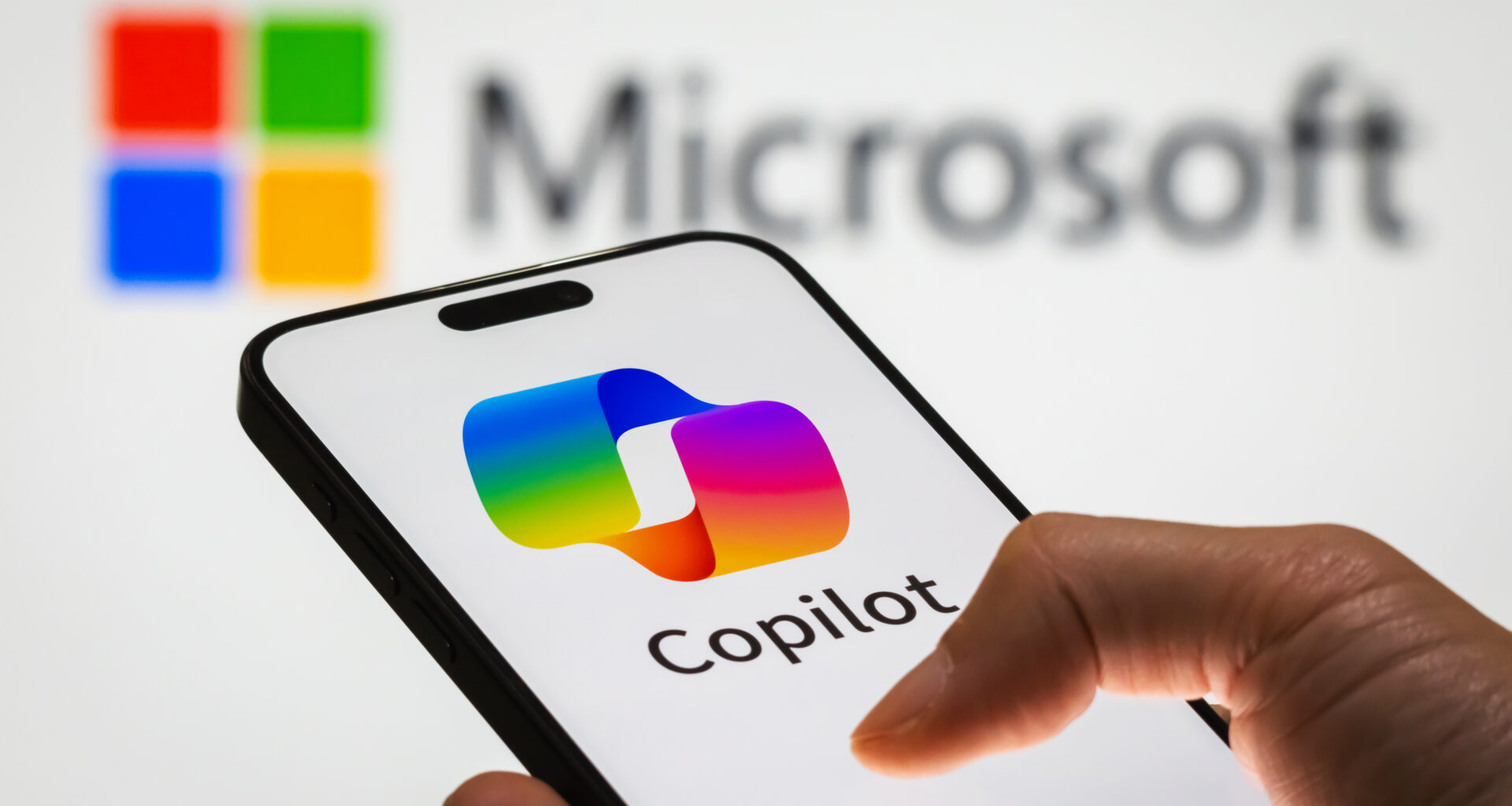 CHONGQING, CHINA - DECEMBER 29: In this photo illustration, a person holds a smartphone displaying the logo of Microsoft Copilot, an AI-powered productivity tool, with the Microsoft logo visible in the background, representing the integration of artificial intelligence into workplace solutions, on December 29, 2024 in Chongqing, China. Artificial Intelligence (AI) has become a cornerstone of Chinaâ€™s strategic ambitions, with the government aiming to establish the country as a global leader in AI by 2030. (Photo illustration by Cheng Xin/Getty Images)