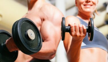 Man and woman holding a dumbbell in hand performing a bicep curl