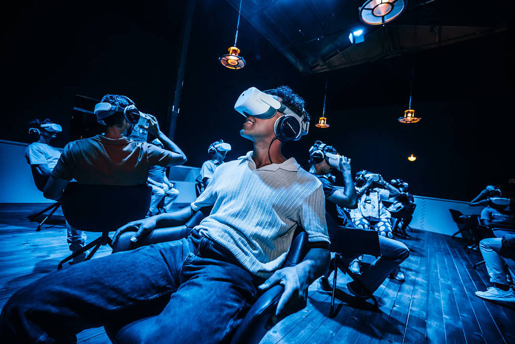 a man in a VR headset looks in awe at the Legend of the Titanic exhibition