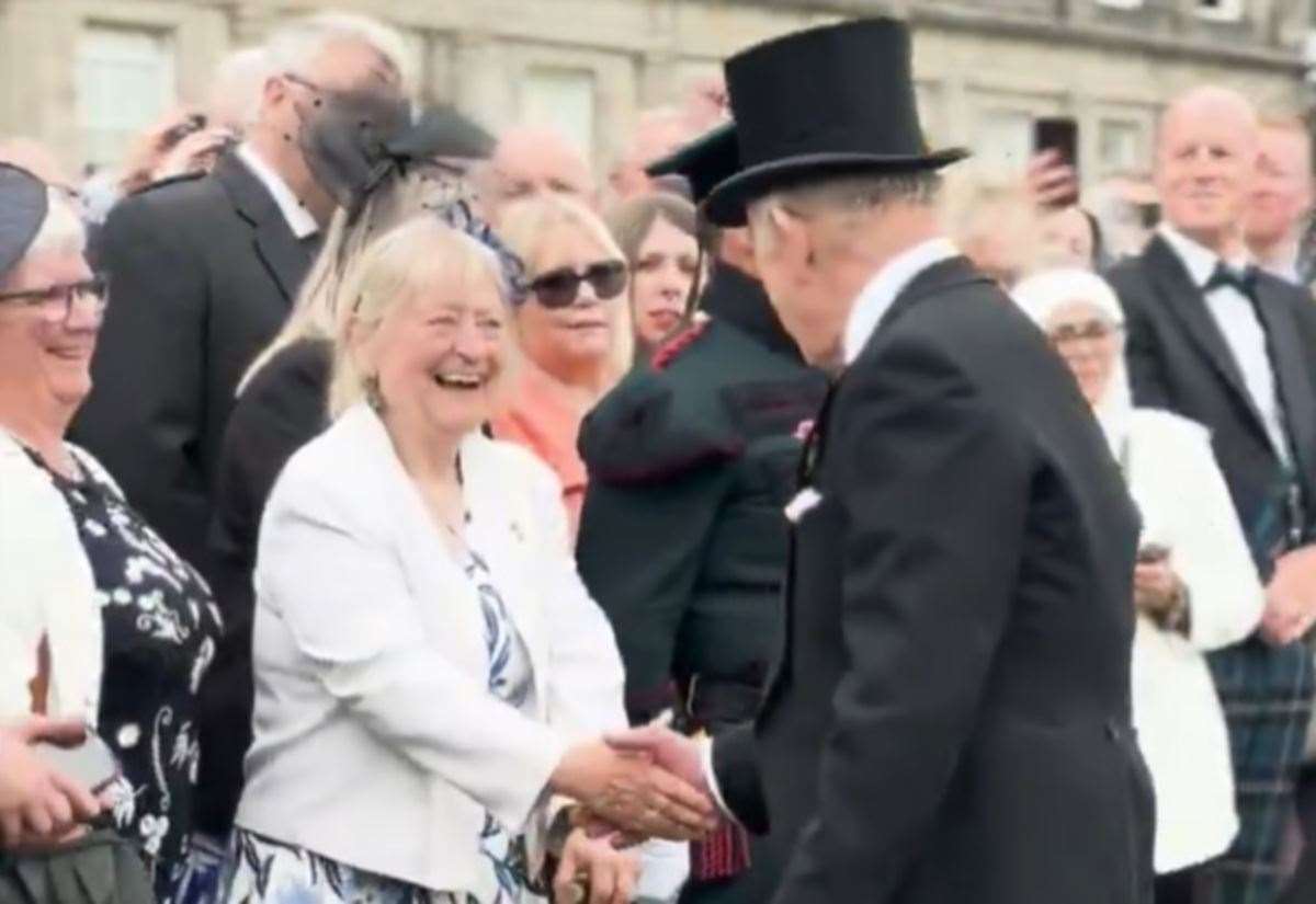King Charles III greets Inverness community stalwart Dell McClurg during Royal Garden Party at the Palace of Holyroodhouse in Edinburgh