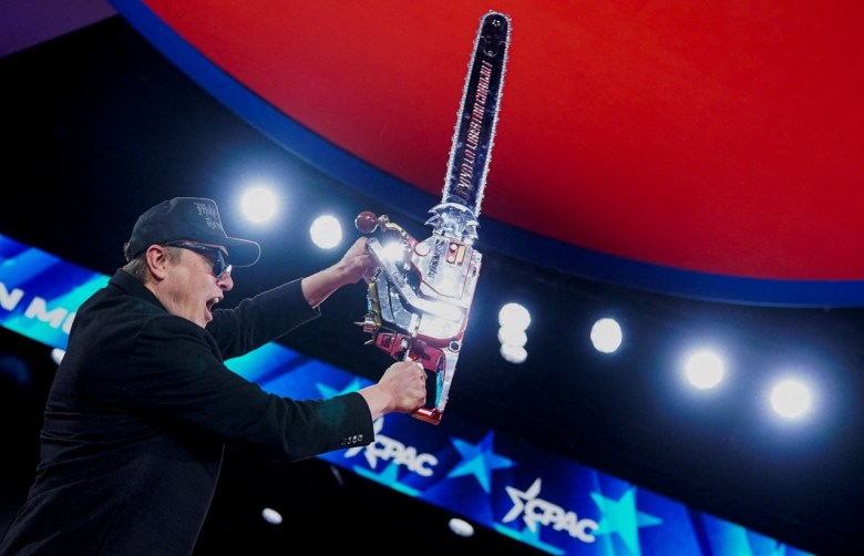 Elon Musk with a chainsaw