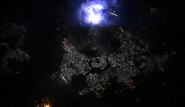 A glowing ball of light is seen over the city lights of Singapore during the night