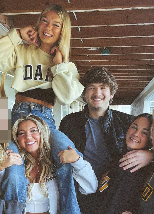 Group of young adults posing for a photo.