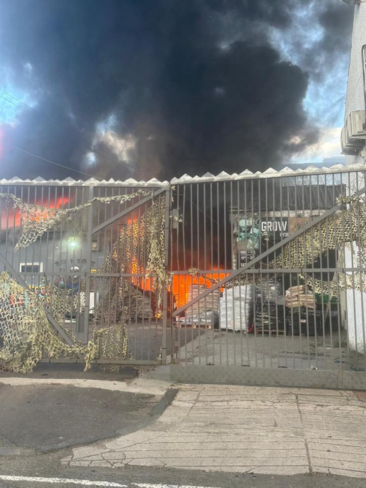 Building fire behind a gate.