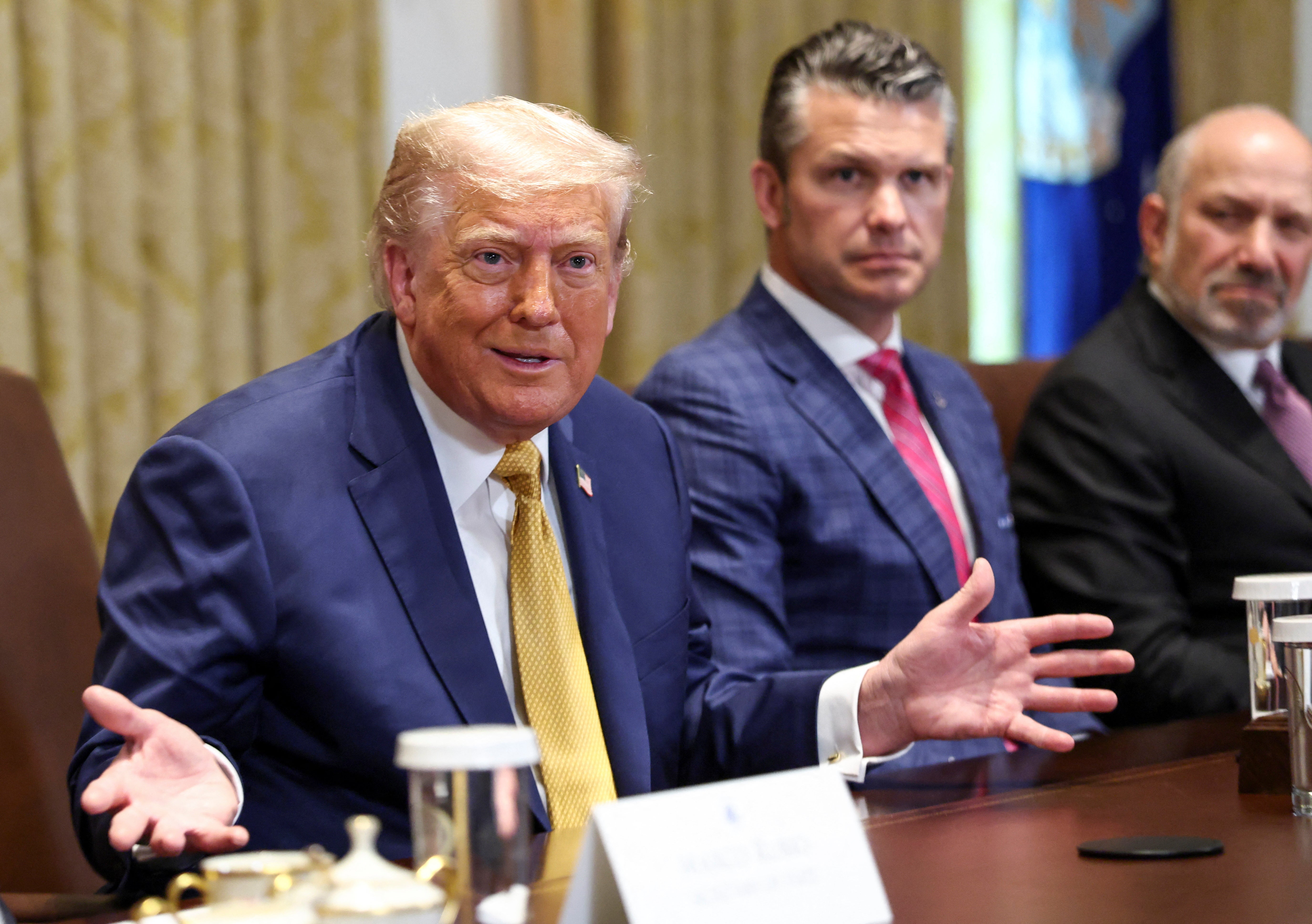 US president Donald Trump speaks next to defence secretary Pete Hegseth during a cabinet meeting at the White House in Washington, DC