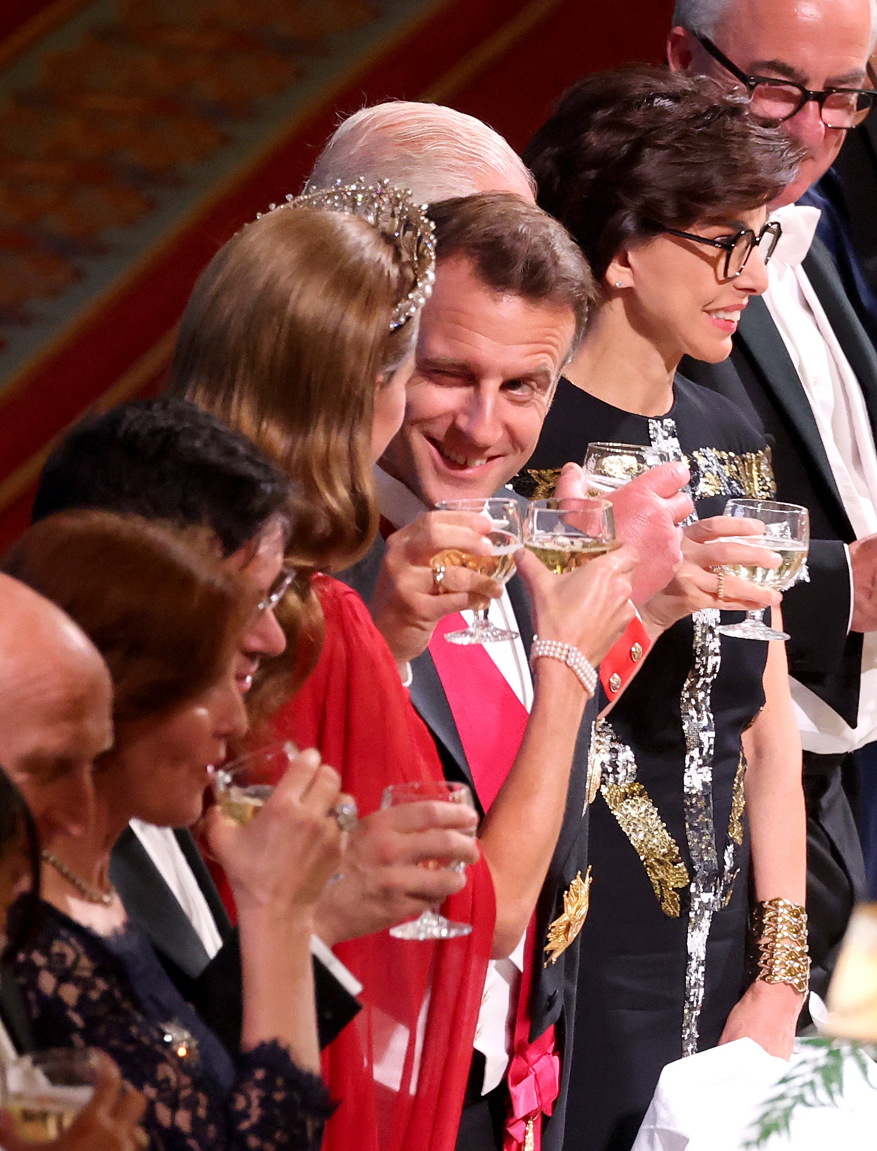 The president was pictured winking and chatting with Kate as she sat next to Mr Macron.