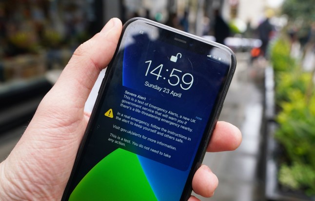 A test of a new public alert system on a mobile phone on Regent's Street in London. Picture date: Sunday April 23, 2023. PA Photo. Every device using the 4G and 5G networks is part of a trial of a system designed to warn the public if there is a danger to life nearby, with a loud siren due to sound for about 10 seconds. Once established, the system is intended to be used in life-threatening situations including flooding and wildfires. See PA story POLITICS Alerts. Photo credit should read: James Manning/PA Wire