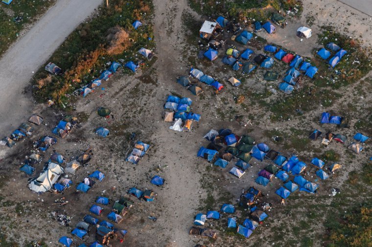 TOPSHOT - This aerial picture taken on September 16, 2023, from a police aircraft belonging to the French Police Aux Frontieres (PAF) shows migrants' tents at a camp on the outskirts of the city of Calais, northern France. (Photo by Sameer Al-DOUMY / AFP) (Photo by SAMEER AL-DOUMY/AFP via Getty Images)